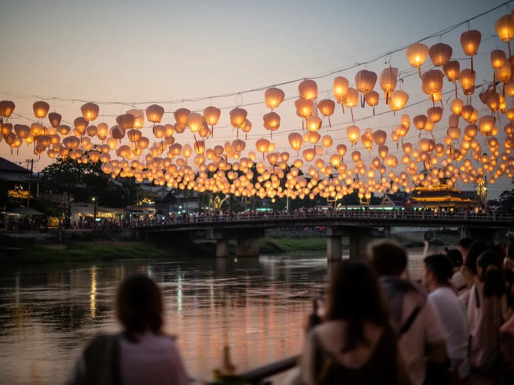 Nawarat Bridge strung with paper lanterns above the Ping River during Yi Peng evening