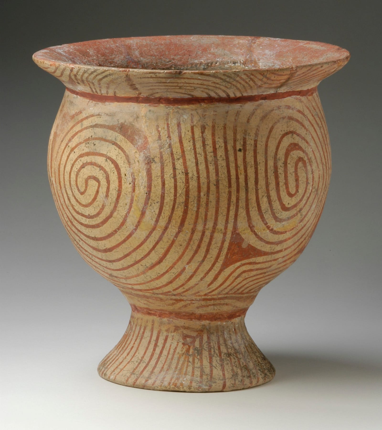 Red-painted Ban Chiang pottery jar with the characteristic spiral designs