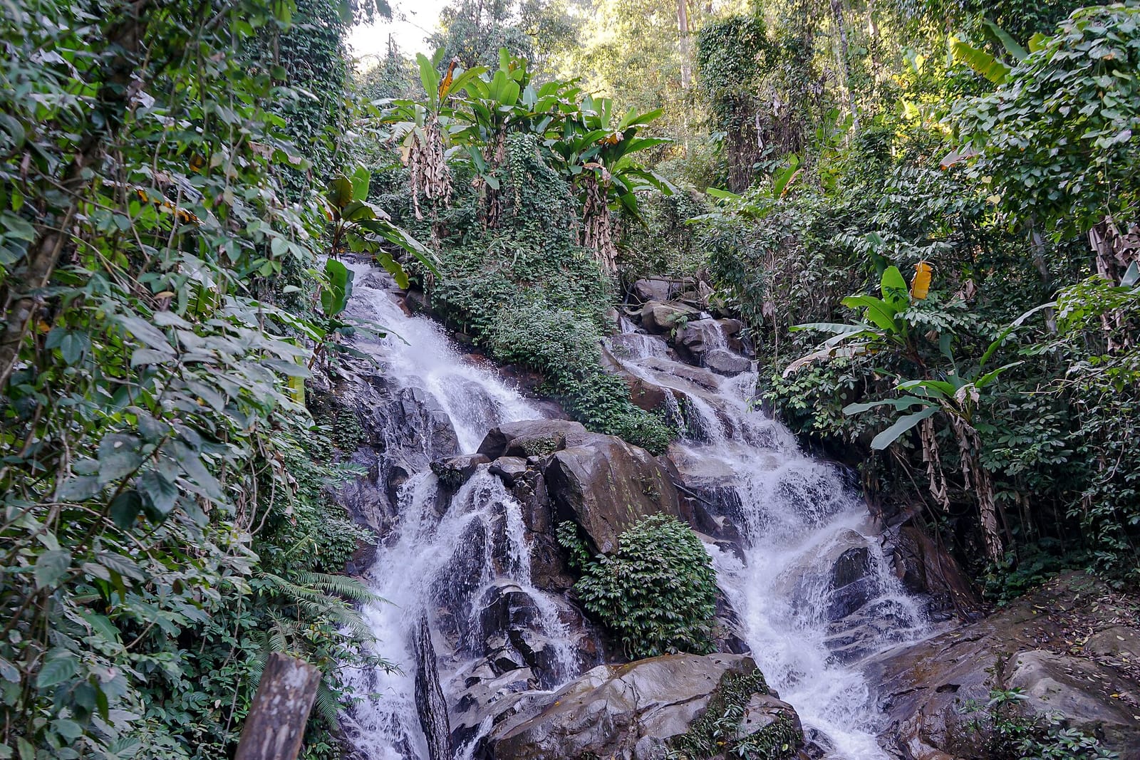 Huay Kaew waterfall at the base of Doi Suthep tumbling over boulders through thick forest