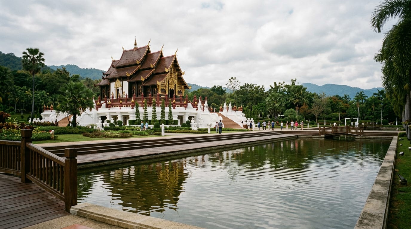 Ho Kham Luang Royal Pavilion at Royal Flora Ratchaphruek, gilded tiered roof reflected in a long ornamental pond
