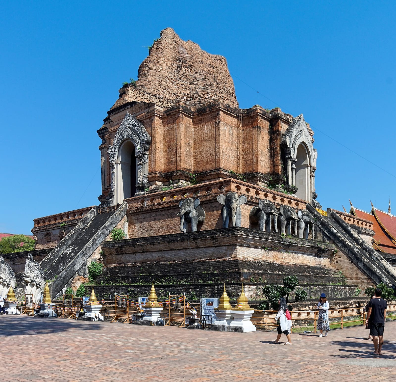 The great chedi seen from a corner of the platform, showing the elephant figures along the lower base between the staircases