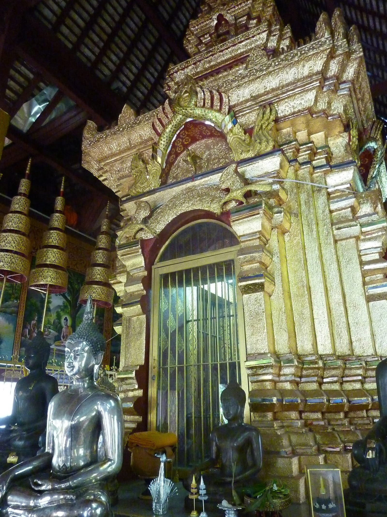 Gilt mondop on the altar of the smaller viharn, its locked grille protecting the crystal Phra Setangkhamani Buddha
