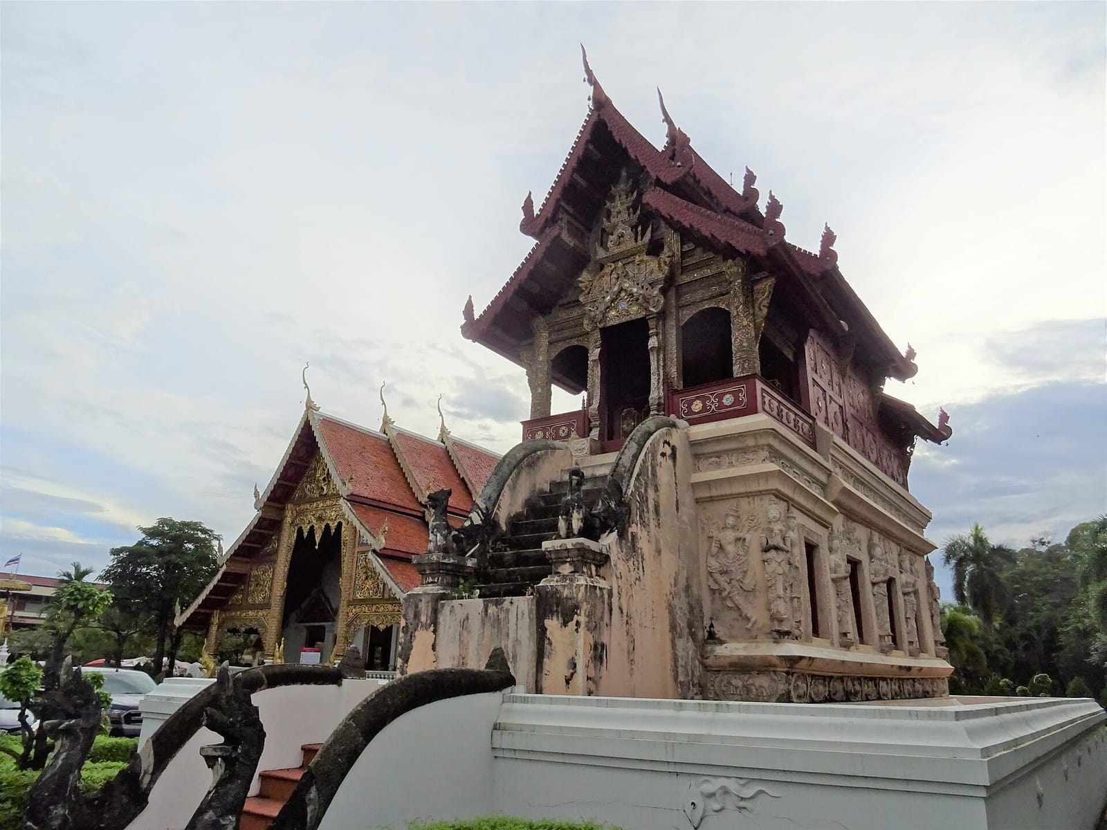 The raised teak ho trai scripture library set on a high masonry plinth to protect manuscripts from termites and floods
