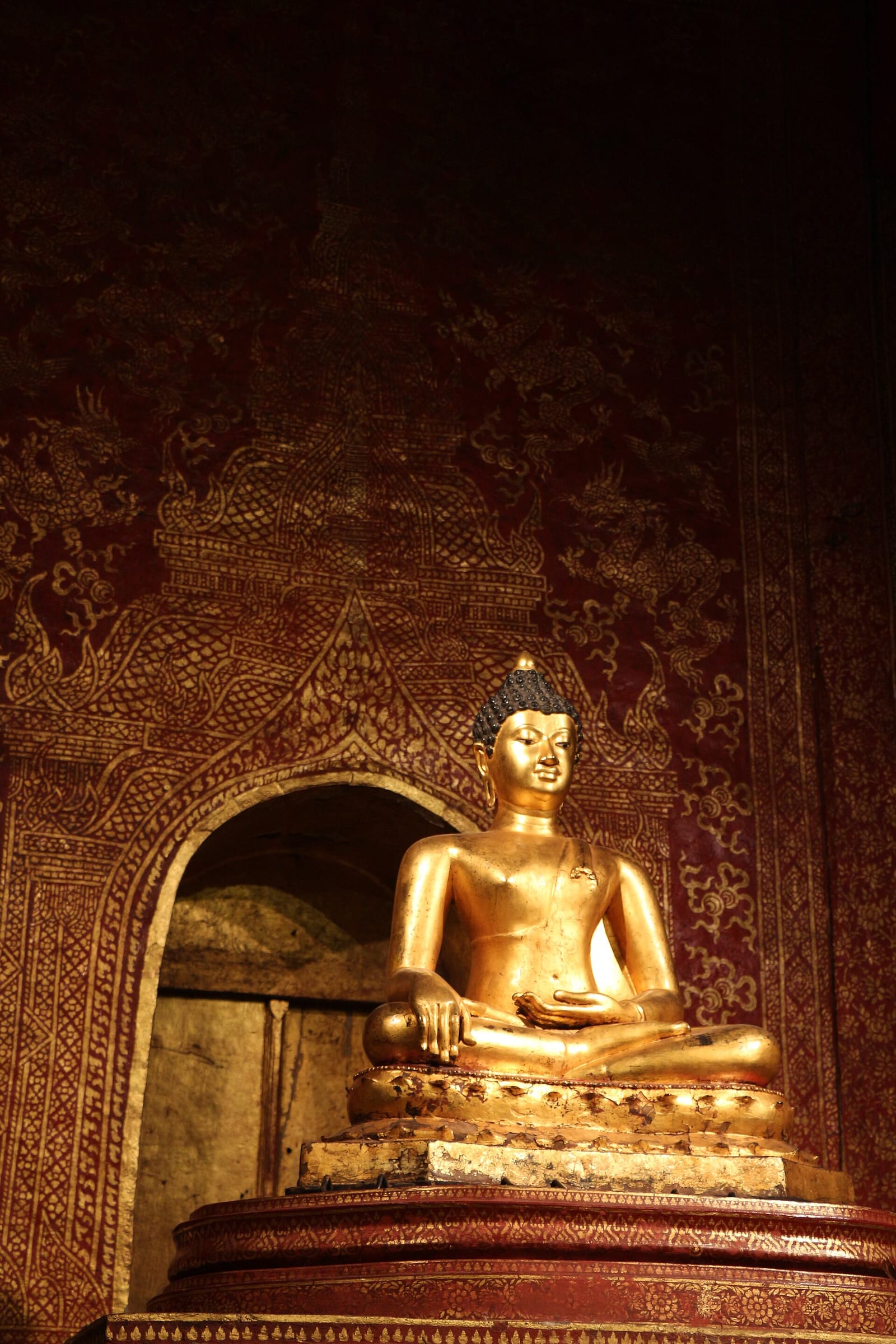 The Phra Buddha Sihing image inside the Lai Kham viharn, seated in the maravijaya posture