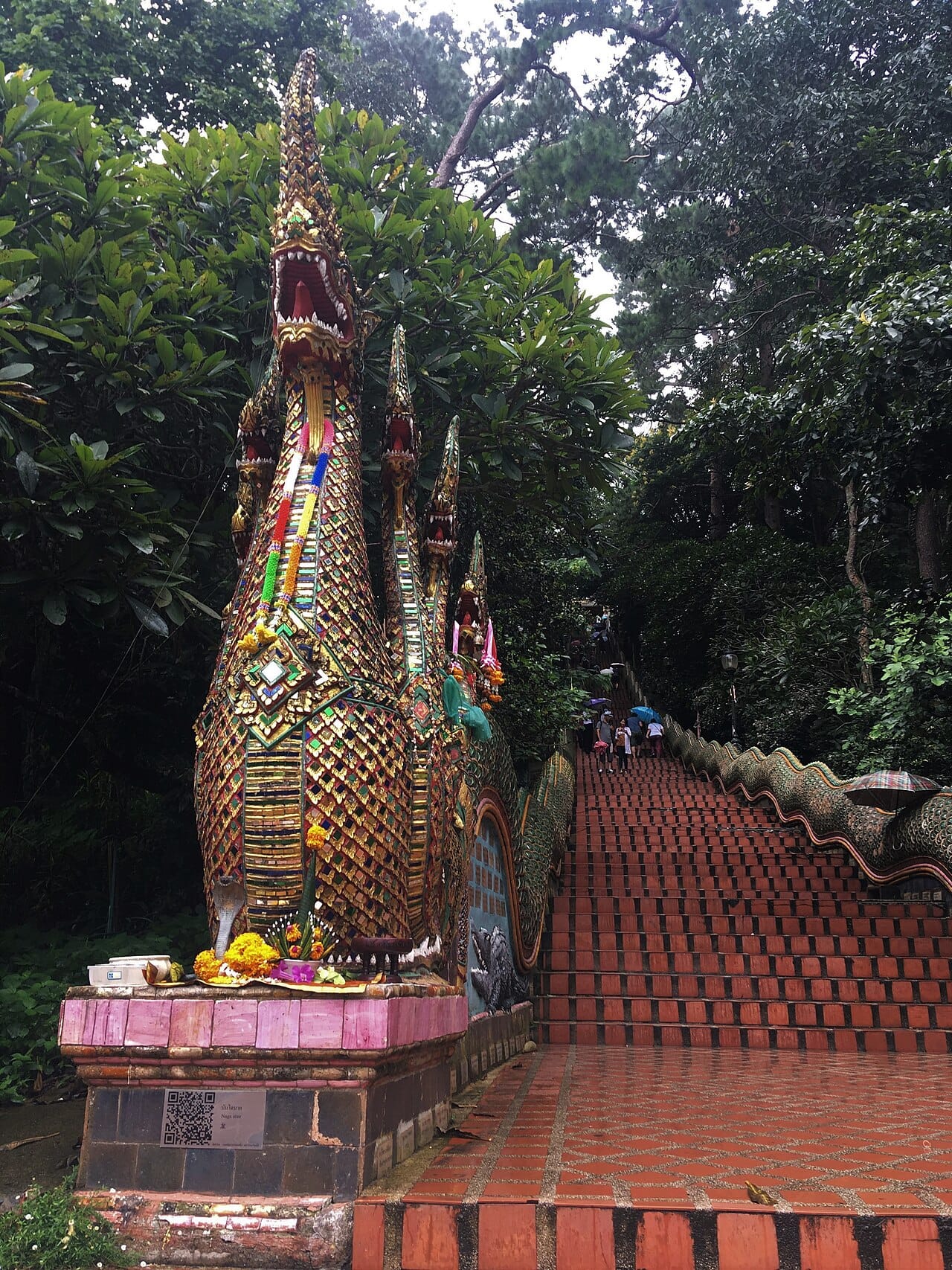 The 306-step naga staircase climbing through the forest to the temple gate, with multi-headed serpent balustrades