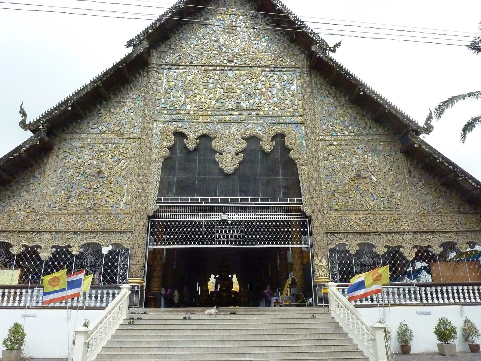Front facade of the main viharn of Wat Suan Dok, with its wide decorated gable above twin entrance staircases